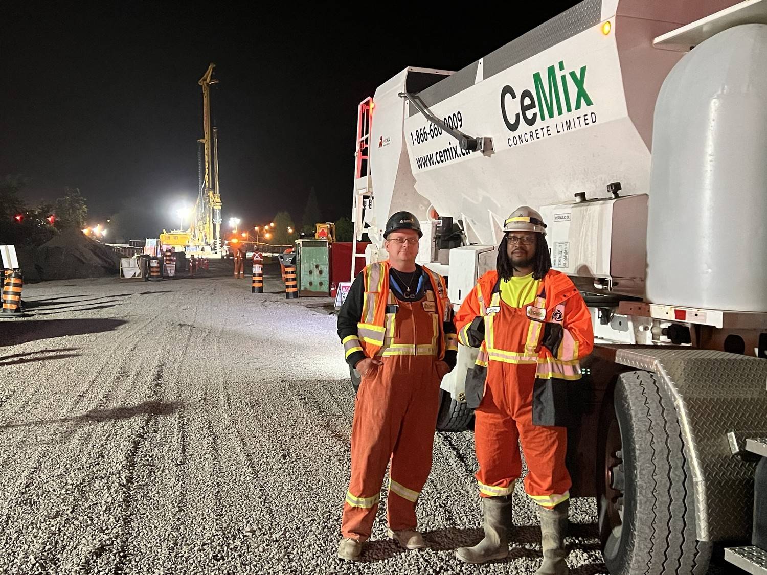 CeMix Concrete Limited crew posing next to a mobile concrete mixer truck on a commercial job site in Lincoln Ontario. 